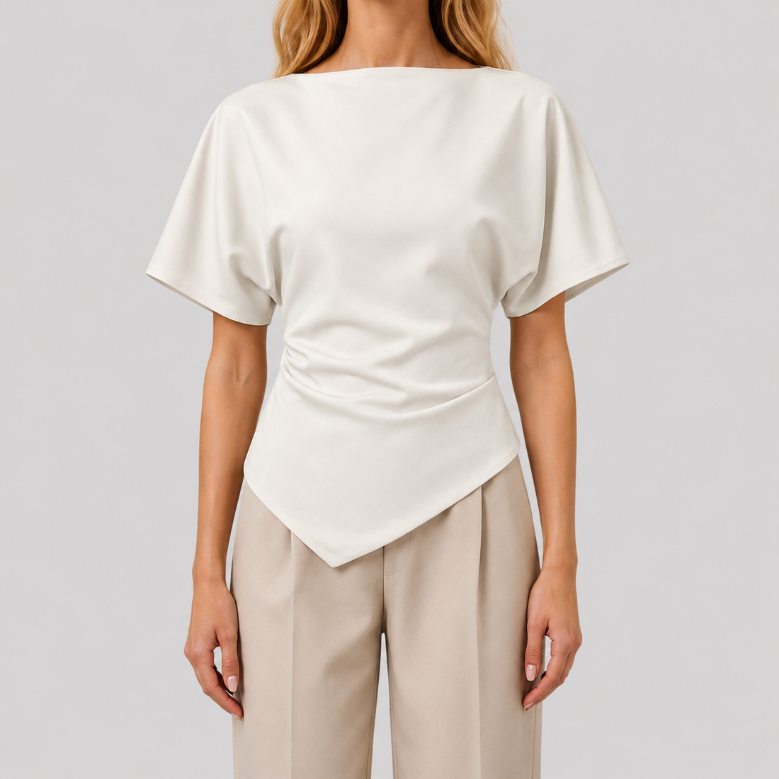 Structured blouse with bateau neckline, short draped sleeves, sculpted waist, and asymmetrical hem for a modern elegant silhouette