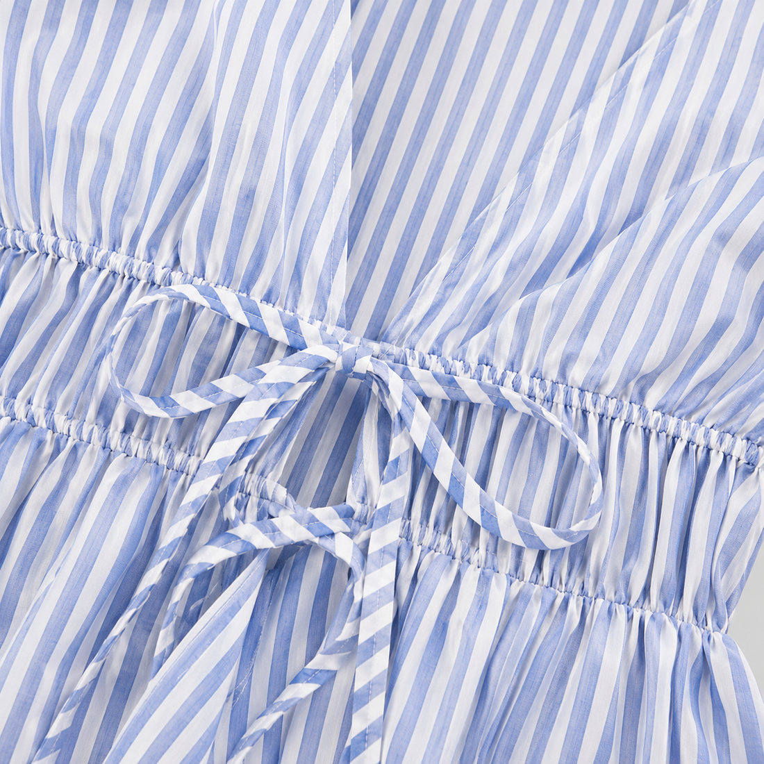 Striped tie-waist blouse with deep V-neck open front, long bell sleeves, and flared hem for a feminine tailored silhouette