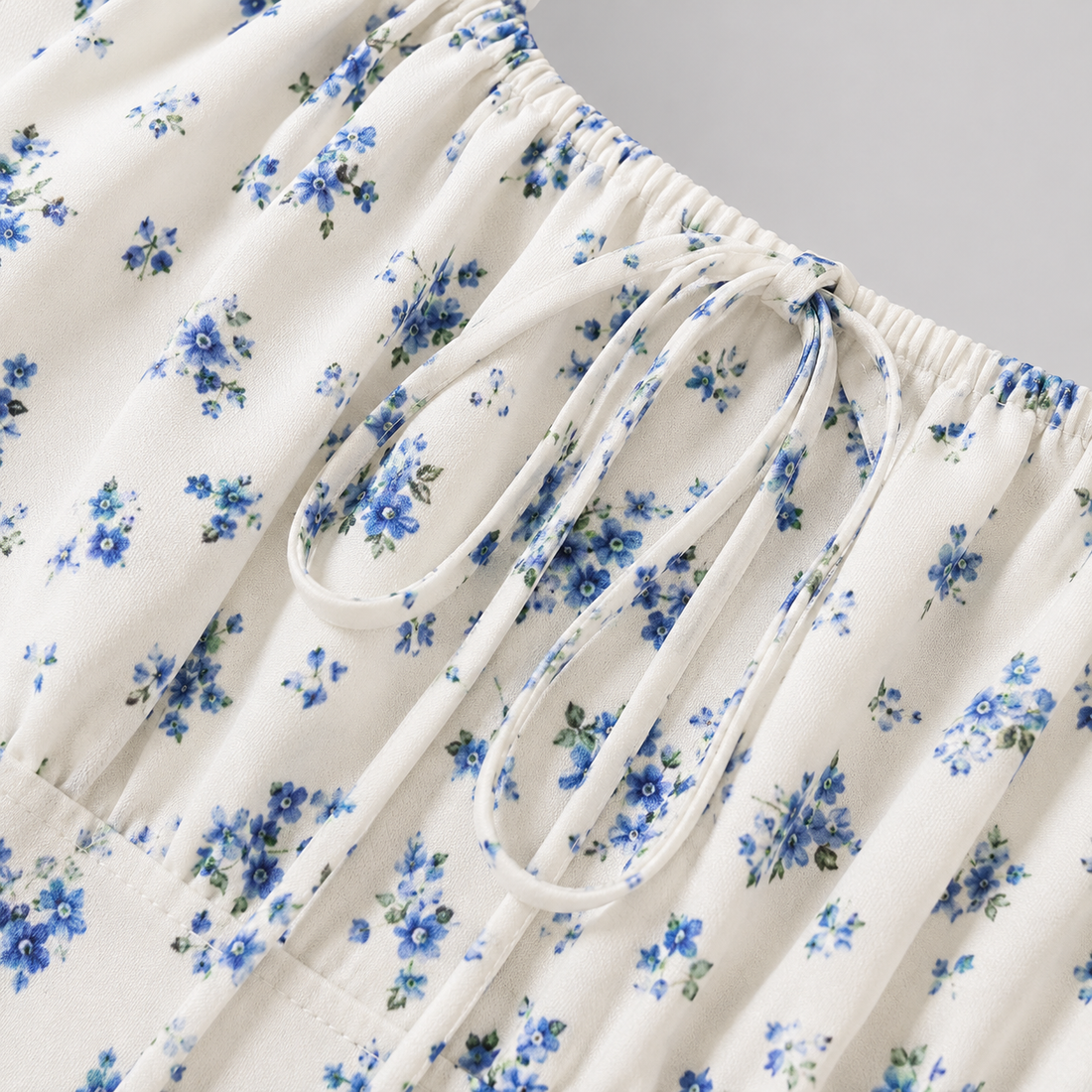 Floral mini dress with square neckline, front tie detail, short puff sleeves, and fit-and-flare silhouette