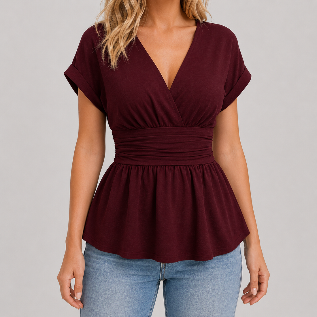Cap sleeve peplum blouse with surplice V-neckline, wide cinched waistband, and flowy hem for an elegant flattering fit