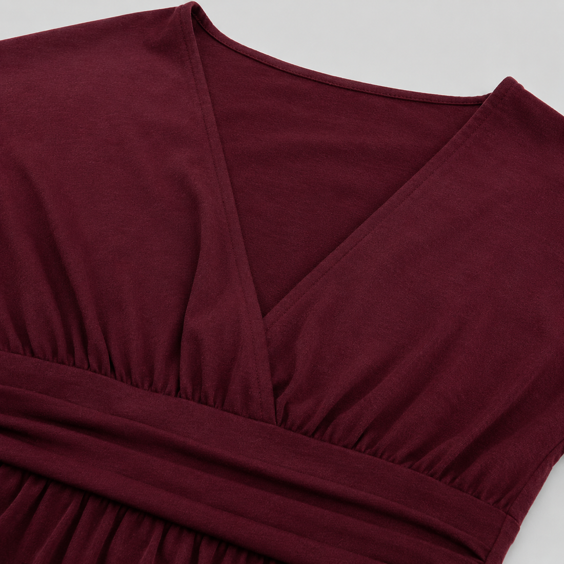 Cap sleeve peplum blouse with surplice V-neckline, wide cinched waistband, and flowy hem for an elegant flattering fit