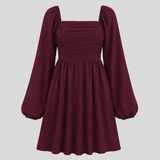 Long sleeve mini dress with square neckline, pleated bodice, defined waist, and flowy fit-and-flare silhouette