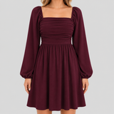 Long sleeve mini dress with square neckline, pleated bodice, defined waist, and flowy fit-and-flare silhouette