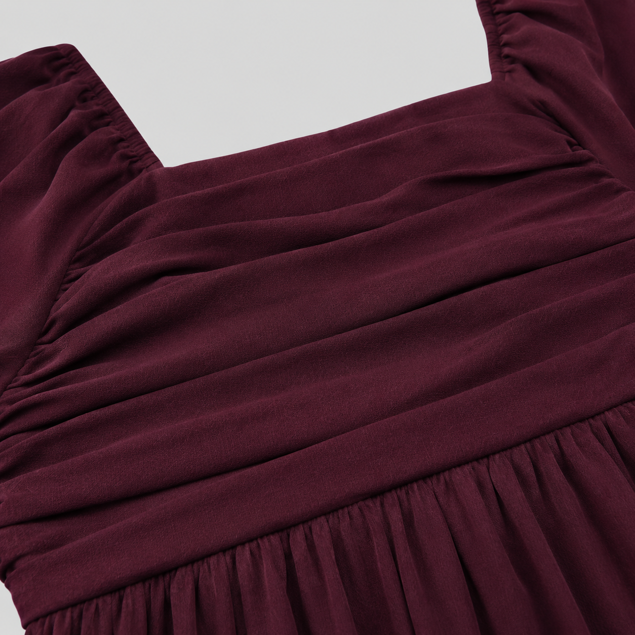 Long sleeve mini dress with square neckline, pleated bodice, defined waist, and flowy fit-and-flare silhouette