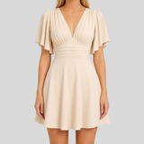 Flutter sleeve mini dress with deep V-neckline, gathered bodice, defined waistband, and fit-and-flare silhouette