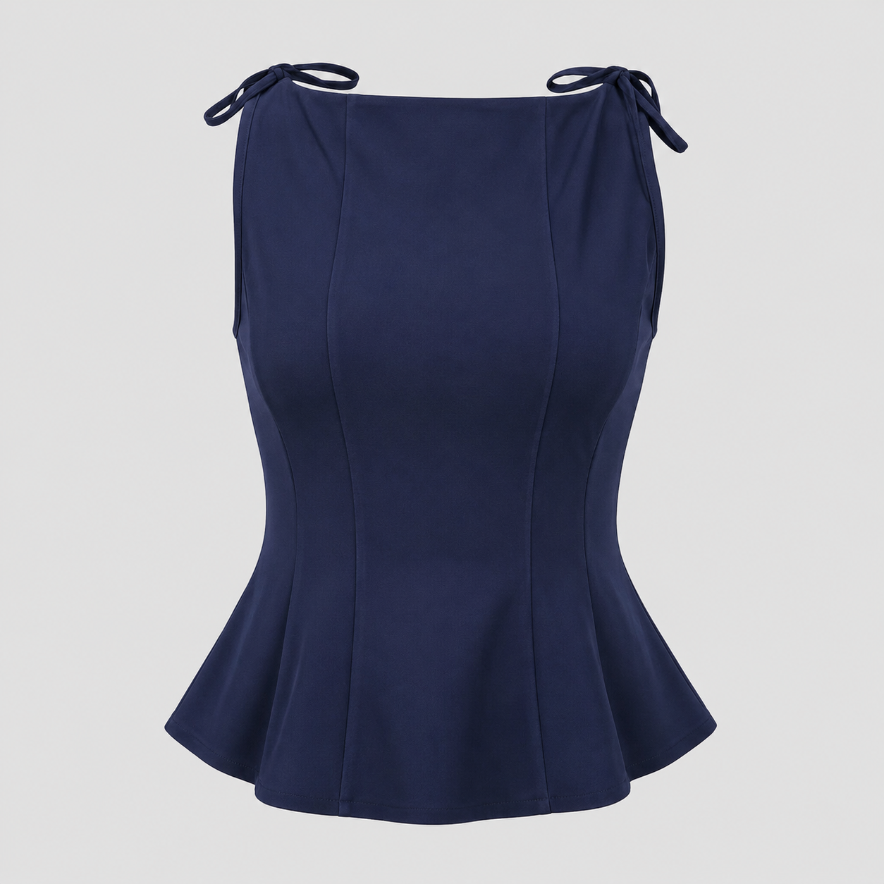 Sleeveless peplum top with boat neckline, shoulder tie accents, sculpted seams, and tailored waist for an elegant structured silhouette