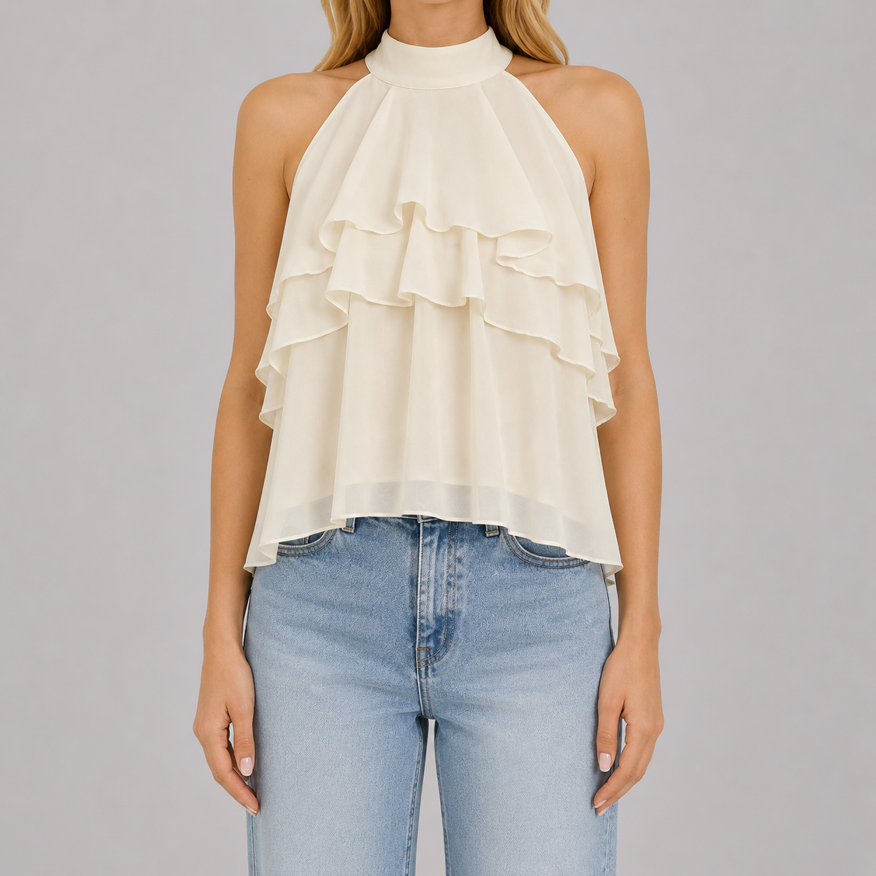 Sleeveless halter blouse with mock neckline, tiered cascading ruffles, and flowy chiffon silhouette for an elegant feminine look
