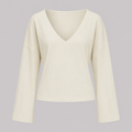V-neck fitted top with gathered waist, long drape sleeves, and a sleek modern silhouette