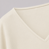 V-neck fitted top with gathered waist, long drape sleeves, and a sleek modern silhouette